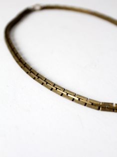 This is a vintage brass chain link necklace.  Square notched links slither together to shape the necklace with a spring ring clasp.  CONDITION In good condition with a nice patina to the brass.  MEASUREMENTS Length:  21"  ..  53.3 cm Width:  0.25"  ..  0.6 cm 91806 Vintage Antique Gold Brass Chain Necklace, Vintage Brass Chain Necklace In Antique Gold, Vintage Bronze Brass Chain Necklace, Vintage Snake Chain Necklace, Vintage Metal Snake Chain Necklace, Vintage Metal Chain Necklace With Lobster Clasp, Vintage Brass Necklace With Gold Chain, Vintage Brass Box Chain Necklace, Vintage Box Chain Necklace