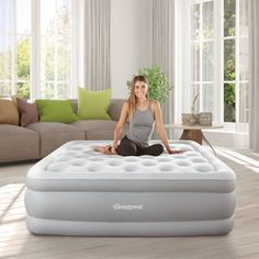 a woman sitting on top of an inflatable mattress