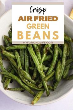 green beans in a white bowl with the words crisp air fried green beans on top