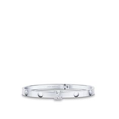 Cast in 18-kt white gold, the empreinte unisex bangle features nail-head imprints, a nod to the house’s trunk-making heritage. The lv initials motif adds a bold signature touch and also serves as a clasp for this hinged bracelet. Available in several sizes, this modern jewel can be worn solo or stacked with other pieces for an on-point look. Luxury White Gold Engraved Cuff Bracelet, Luxury Engraved White Gold Cuff Bracelet, Timeless Platinum Jewelry With Palladium Hardware, Designer White Gold Bangle For Anniversary, Timeless White Gold Jewelry With Palladium Hardware, Designer White Gold Bracelets For Everyday Luxury, Designer Engraved White Gold Bracelets, Designer White Gold Bangle With Jubilee Bracelet, Designer White Gold Bangle