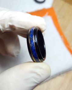 "Ebony exotic wood ring, with a centered band of crushed intense blue Lapizlasuli gemstone from Afghanistan and 18k solid Gold inlays. 🌜💙 Lapis Lazuli is a powerful stone for activating the higher mind and enhancing intellectual ability. It was among the most highly prized tribute paid to Egypt, obtained from the oldest mines in the world, worked from around 4000 B.C. and still in use today. Treasured by the ancient Egyptians for its powerful ability to bring about insight and spiritual transf Egyptian Kings And Queens, Mens Engagement Ring, Obsidian Ring, Ancient Egyptians, Mens Engagement, Lapis Lazuli Ring, Wood Ring, 18k Gold Ring, Wedding Idea