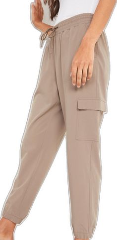 Sporty Cargo Pants With Side Pockets For Work, Sporty Cargo Pants With Multiple Pockets For Work, Beige Cargo Pants With Elastic Waistband For Work, Sporty Beige Pants With Pockets, Sporty Solid Cargo Pants For Workwear, Sporty Ankle-length Cargo Pants With Side Pockets, Khaki Utility Joggers With Side Pockets, Khaki Athleisure Bottoms With Pockets, Sporty Cargo Pants For Workwear