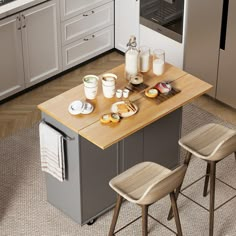 a kitchen island with two stools in front of it and food on the counter