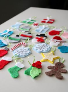 felt christmas ornaments are laid out on a table