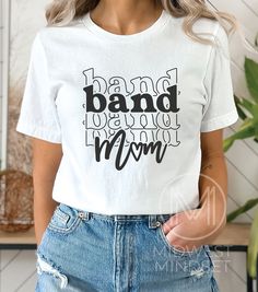 Band Mom Shirt, Marching Band Mom, Band Mom Life Tee, Drumline Mama, Gift for Band Mom, All About Halftime Shirt, Band Mama Shirt Bella Canvas 3001T:  T-Shirt Sizing Please reference the size chart before selecting shirt size.  Use one of your own t-shirts to measure the size and fit.  Then compare with the size chart provided to ensure an accurate fit. T-Shirt Materials 100% combed and ring-spun cotton. Heather colors are 90% combed and ring-spun cotton, 10% polyester. Pre-shrunk fabric. Should Mom Life Shirt Ideas, White Cotton Shirt With Band Logo, White Cotton Shirt With Lettering, White Cotton Band Logo Top, Casual Cotton Shirt With Band Logo, White Cotton Top With Band Logo, Cotton Band Merch Tops With Lettering, Band Mom Shirts Ideas, Diy Band Shirt