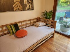 a day bed with pillows on top of it in front of a sliding glass door