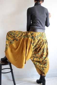 "Keep on the funky side of life. Harem pants made from super full balloon shape skirt. We used at least 5 meters of fabric on this item. Elastic waist. Gathered in pleats around the whole waist. Patched on the sides with big ruffle piece in triangle shape. Then gathered on the bottom part in shirring smock to make the leg hole. 2 kinds of fabric. Floral print in the middle and solid color fabric on the side (in dark color, the print is subtle) Beautiful and flattering to woman in all shape. Lots Fall Bohemian Harem Pants, Bohemian Harem Trousers For Fall, Bohemian Harem Pants For Fall Festival, Relaxed Fit Hippie Harem Bottoms, Bohemian Harem Pants For Fall, Bohemian Baggy Bottoms For Fall, Baggy Bohemian Bottoms For Fall, Baggy Lagenlook Harem Pants For Spring, Fall Harem Pants