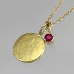 Hammered Disc with Ruby Drop Necklace in 14k Gold (16") 14k Gold Round Coin Necklace Fine Jewelry, Elegant Gold Birthstone Necklace In Recycled Gold, Dainty Gold Birthstone Necklace With Round Stone, Gold Plated Birthstone Necklace With Round Pendant, Gold Dainty Birthstone Necklace With Round Stone, Gold Plated Yellow Gold Birthstone Necklace, Yellow Gold Plated Round Birthstone Necklace, Yellow Gold Birthstone Necklace With Round Pendant, Yellow Gold Round Birthstone Necklace Gold Plated