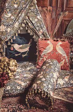 a bed with pillows and some birds on it