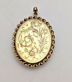 9ct Yellow Gold Oval Locket Pendant Size: 29mm x 40mm Enhance your jewellery collection with our exquisite 9ct Yellow Gold Oval Locket Pendant, a timeless piece crafted with elegance and sophistication. We aim to pack and dispatch your order within 1 - 2 working days once payment has cleared. Please note that most of our orders may require a signature upon delivery. If you are not available, Royal Mail will leave a card explaining how to receive your goods. If you do not receive your goods within the agreed time, please contact us immediately, and we will strive to resolve the matter promptly. For instances such as changing your mind, ordering by mistake, not liking the item, it not fitting, or finding a better price, you may return the item at your own expense. However, the item must be r Formal Yellow Gold Oval Pendant Jewelry, Classic Oval Pendant Jewelry For Wedding, Classic Yellow Gold Oval Cabochon Jewelry, Luxury Oval Locket Jewelry, Ornate Gold Oval Cabochon Jewelry, Luxury Hallmarked Jewelry, Luxury Oval Jewelry With Engraving Option, Victorian Oval Jewelry With Engraving Option, Victorian Engraved Oval Cabochon Jewelry