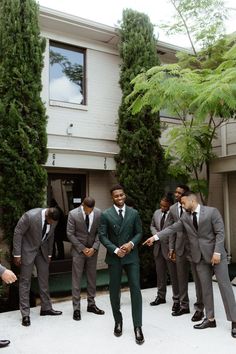 a group of men in suits standing around each other