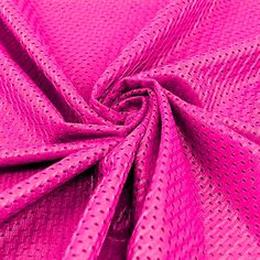 a close up view of the fabric in pink color, with small dots on it