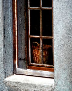 a basket is sitting in the window sill