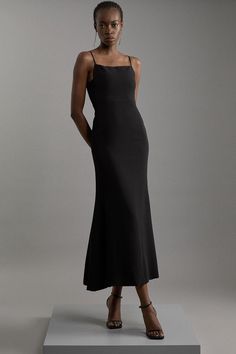 Delivering A Combination Of Dressed-Down Glamour And Statement Style, Discover Collections: 06 Partywear. Experience Elevated Elegance Our Tailored Maxi Dress, With A Sleek, Minimal Design, A Squared Neckline, And Strappy Shoulders. Pair This Piece With Strappy Heels For An Outfit Perfect For Race Days And Formal Occasions. Compact Stretch Viscose Tailored Square Neck Maxi Dress High Quality Stretch Fabric Sleek Design Uniquely Angular Squared Neckline Floor Grazing, Maxi Length Adjustable Spagh