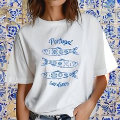 Celebrate the vibrant culture of Portugal with our exclusive oversized t-shirt featuring a charming sardines design! Perfect for those who love unique and stylish apparel, this t-shirt effortlessly combines comfort with a touch of Mediterranean flair. Add a touch of Portuguese charm to your wardrobe with our oversized sardines t-shirt. Order yours today and embrace the spirit of Portugal in style! PLEASE NOTE that your purchase is custom printed, unfortunately we do not allow returns or exchanges. All shirts are made with 100% airlume, ring-spun and combed cotton for extra softness. (Athletic Heather is 90% / 10% airlume combed and ring-spun cotton / polyester) .: 100% airlume combed and ring-spun cotton .: Medium fabric (6.0 oz/yd² (170 g/m .: Relaxed fit .:Tear-away label IF you have any