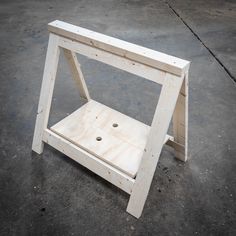 a wooden table sitting on top of a cement floor