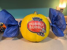 there is a large pumpkin that has been wrapped in blue paper and sits on the counter