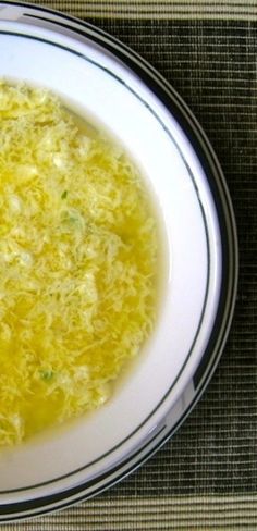 a white bowl filled with soup on top of a table