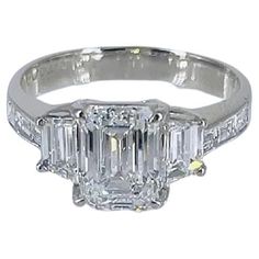 This handmade, three-stone ring recently acquired by the house of J. Birnbach features a natural, certified 1.61 carat emerald cut diamond of F color and VS2 clarity as described by GIA grading report # 1378269503. Flanked by a pair of beautifully matched, step-cut trapezoid diamonds = 0.58 carat total weight and straight baguettes = 0.30 carat total weight, this piece is exceptionally big looking for the described carat weight. With a coveted 1.36 ratio, excellent polish and no fluorescence, this diamond is the most aggressively priced diamond of its size / make in the international diamond marketplace. Possessing an Art Deco aesthetic with the thoughtful arrangement of step-cut diamonds, this piece is guaranteed to be an heirloom treasure for generations to come! Purchase includes compli Art Deco Aesthetic, Emerald Cut Diamond Ring, Proposal Box, Emerald Cut Diamond, Step Cut, Three Stone Rings, Emerald Cut Diamonds, Gigi Hadid, Jewelry Rings Engagement