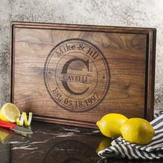 a cutting board with some lemons next to it