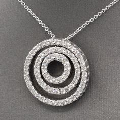 This necklace brings all the sparkle and bling! Three concentric circles are attached at the top (the middle circle floats) to form a dynamic and powerful piece. The circles are encrusted with natural earth-mined diamonds measuring 1.5mm each, for a total approximate carat weight of 72 stones equaling 1.08cttw. The diamonds are fully cut round brilliant, H/I color and SI2 average clarity. There are no eye visible inclusions and the stones are bright white and sparkly! The pendant measures just o Concentric Circles, Circle Diamond, Natural Earth, Diamond Pendant Necklace, Diamond Pendant, Round Brilliant, Bright White, Circles, Diamonds