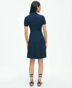 A new polo play, our wrap dress is made from butter-soft cotton modal knit in a classic pique pattern. A functional wrap silhouette, full skirt and smoothing power mesh lining make this a stylishly comfortable way to spend your spring-summer days. Featuring ribbed collar and our Golden Fleece® logo on the chest.39" center back lengthBodice fully lined with power meshSnap at bust for modesty57% Cotton, 39% Modal, 4% SpandexMachine Wash according to care instructions for best resultsImported | Women's Polo Wrap Dress in Pique Cotton Modal Blend | Navy | Size Medium Chic Fitted Polo Dress With Collared Neckline, Fitted Polo Dress For Spring, Fitted Polo Dress For Work With Collared Neckline, Elegant Fitted Collared Polo Dress, Fitted Solid Polo Dress For Spring, Versatile Fitted Short Sleeve Dresses, Elegant Fitted Polo Dress With Collared Neckline, Versatile Fitted V-neck Dress, Versatile V-neck Fitted Dress