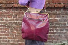 Malaga purple top clip handbag, Large clip lock purse, Purple leather clasp lock vintage style cross body, Adjustable kiss clip purse purple Giant clip frame top clip vintage-style clasp bag crossbody in beautiful smooth purple leather with adjustable handle measures 31 x 34cms, strap is 2.5cms by 154 cms and the internal zip pocket is 18 x 18cms is a real gem and new on our list. Clasp frame or kiss lock bags have that irresistible retro-looking feel and the purple shade in this bag adds that vibe in spades. Retro Purple Shoulder Bag For Everyday Use, Vintage Purple Bags For Formal Occasions, Vintage Burgundy Shoulder Bag For Everyday, Vintage Bag With Fold Over Clasp For Everyday Use, Vintage Shoulder Bag With Fold Over Clasp, Vintage Purple Bag For Everyday Use, Purple Vintage Travel Bag, Vintage Purple Shoulder Bag For Daily Use, Vintage Purple Travel Bag