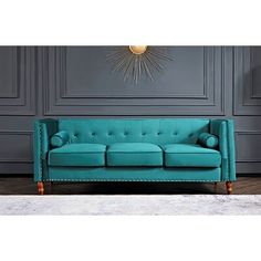 a blue couch sitting in front of a gray wall