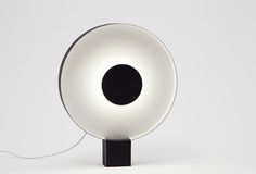 a black and white lamp sitting on top of a table