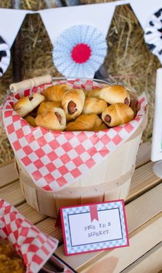 a basket filled with bread on top of a wooden table