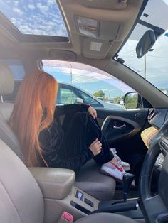 a woman sitting in the passenger seat of a car