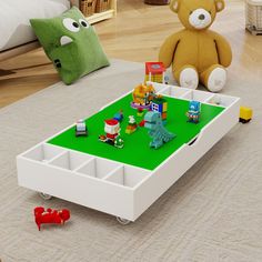 there is a lego table with toys on it and a teddy bear in the background