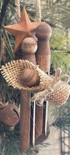 an ornament made out of wood and burlocks hanging from a tree