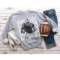 This makes the perfect vintage school spirit sweatshirt! Game Day! This distressed football sweatshirt is great for the sports moms and gift for high school football fans! This vintage football player is perfect on the popular Gildan brand sweatshirt. This vintage style sweatshirt will keep you warm throughout the football season!  A pre-shrunk, classic fit sweater that's made with air-jet spun yarn for a soft feel and reduced pilling. ** P R O D U C T **  - 50% cotton, 50% polyester  - Pre-shrunk  - Classic fit  - Direct to Garment print (no stencils or vinyl which means it will last a lot longer)   - Printed and Shipped in the USA  - Due to different monitor screens colors may vary ** S I Z I N G **  - Consult size chart in listings for measurements  - Sizing is Unisex for all tees, runs Game Day Fan Apparel Sweatshirt In Athletic Heather, College Football Season Graphic Print Sweatshirt, Athletic Heather Sweatshirt For Game Day, Football Season Game Day Cotton Sweatshirt, Game Day Team Name Sweatshirt In Athletic Heather, Football Season Fan Gear Sweatshirt With Graphic Print, Cotton Sweatshirt For Game Day, Football Season, Football Season Graphic Print Fan Gear Sweatshirt, Game Day Screen Print Sweatshirt For Fall