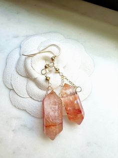 These gorgeous boho style natural red quartz crystal point earrings are a great gift for yourself or someone you love.  Genuine red crystal quartz points dangle from your choice of 14k gold fill or sterling silver earring wire. Each crystal is natural and one of a kind so there will be some variations in color and inclusions. These elegant, simple and minimalist dangly drop earrings will make a perfect gift for dressy or casual occasions and are great for bridesmaids, best friend, anniversary, s Wire Wrapped Healing Drop Earrings, Healing Wire Wrapped Drop Earrings, Crystal Dangle Earrings For Pierced Ears As Gift, Dainty Nickel-free Crystal Earrings For Gift, Gift Crystal Dangle Earrings For Pierced Ears, Bohemian Dangle Jewelry With Mineral Crystal, Bohemian Wire Wrapped Quartz Jewelry, Bohemian Dangle Jewelry In Mineral Crystal, Bohemian Rose Gold Jewelry With Ear Wire