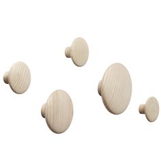 three white wooden knobs on a white background