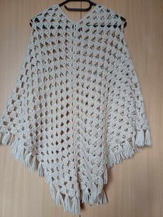 Soft and delicate hand crocheted poncho for women/girls.  Length along shoulder approx 56cm(22in) Material: wool, acrylic Color: ivory Machine washable, dry flat, do not bleach. Handmade Beige Crochet Top, Handmade Beige Poncho One Size, White Crochet Shawl For The Beach, One Size Crochet Yarn Poncho, One-size Crochet Yarn Poncho, One Size Cream Knitted Shawl, Handmade One Size Acrylic Yarn Poncho, Cream Knitted Shawl One Size, Cream Knitted One Size Shawl