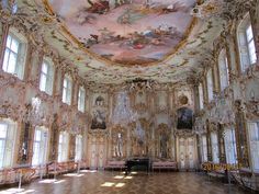 an ornately decorated room with chandeliers and paintings on the ceiling is shown