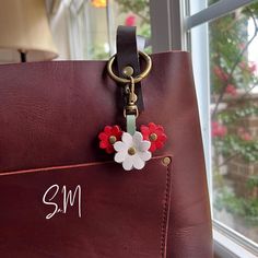 Handmade Triple Mini Flower Leather Bag Charm This charm is displayed on my medium Cognac tote to illustrate size and dimension. This listing is for the charm only - the tote is not included. This charm is handmade by deconstructing and upcycling some of my new and unused Portland Leather collection! Colors used: PLG's Beluga, Ruby, and Cucumber Lobster clasp is small enough to fit on a zipper to be used as a zipper pull, or big enough to hook onto an o-ring for your larger bags and crossbodies. White Bag With Keychain For Everyday Use, Handmade Everyday Flower Bag, Zipper Charms, Large Bag, O Ring, Color Choices, Cognac, Cucumber, Custom Orders