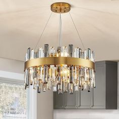 a chandelier hanging from the ceiling in a kitchen