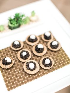 small cookies with black and white toppings on a table