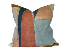 an orange, blue and grey pillow on a white background with a black stripe down the middle