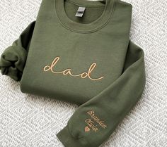 Dad gift, DAD SWEATSHIRT, Custom Embroidered Dad Crewneck with Kids Names Sweatshirt Pregnancy Reveal Gift for New dad Custom Shirt Father's Day Gift Picture: military green sweatshirt with #33 thread color ---HOW TO ORDER--- FOR EACH SHIRT CHOOSE: **Shirt type, size and color 1) names on Sleeve (with heart or without)(please write if you would like a heart) 2) Thread Color # 3) Left or Right Sleeve (when wearing) 4) add to cart! (THERE IS 1 SLEEVE EMBROIDERY and 1 THREAD COLOR INCLUDED) Need bo Pregnant Photoshoot, Gift For New Dad, Dad Sweater, Sleeve Embroidery, Kids Names, Green Sweatshirt, Pregnancy Reveal, Embroidered Crewneck, Personalized Embroidery