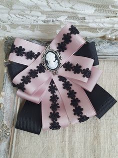 Black Brooch With Decorative Bow Gift, Black Brooch With Decorative Bow As Gift, Black Ribbon Brooches As Gift, Black Ribbon Brooches For Gift, Victorian Pink Brooches For Wedding, Black Bow Tie Brooches For Wedding, Elegant Pink Bow For Gift, Black Bow Tie Brooch For Wedding, Vintage Bow Tie Brooch For Formal Occasions