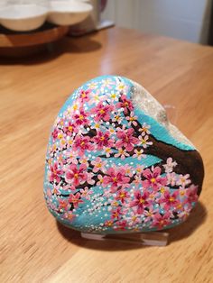 a decorated rock sitting on top of a wooden table