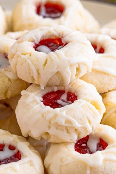 strawberry shortcakes with white frosting and jelly on top are piled up in a pile