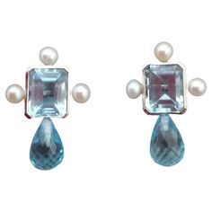 These elegant and handmade earrings have 2 Octagon Faceted Sky Blue Topaz measuring 9 x 11 mm set in a 14 Kt white gold bezel with 3 small round pearls of 4mm on 3 sides at the top to which are suspended 2 Round Drops Faceted Sky Blue Topaz measuring 7 mm x 10 mm. In 1978 our workshop started in Italy to make simple-chic Art Deco style jewellery, completely handmade and using the typical gemstones of that period (1920-1930 circa) : genuine Jades, Turquoise , Lapis Lazuli and other color gemstone Vintage Stud Earrings, Blue Topaz Jewelry, Chic Art, Sky Blue Topaz, Estilo Art Deco, Simple Chic, Earrings Stud, Pearl Stud Earrings, Pearl Studs