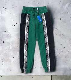 New with tags Adidas RYV Blacked TP green track pants, size Large. Pants in photos are the pants that will ship. See photos for measurements to ensure proper fit. Ships fast from a smoke-free home by USPS Ground Advantage. WOVEN PANTS INSPIRED BY '90S STREETWEAR. Modern comfort with a retro twist. Inspired by '90s sportswear, these track pants have a bold logo look with branded tape on the front. They're made of soft, lightweight plain weave and cut for a relaxed easy-to-wear shape. Relaxed fit Green Track Pants, 90s Sportswear, Large Pants, Green Product, Bold Logo, 90s Streetwear, Mens Fashion Streetwear, Green Logo, Active Wear Pants