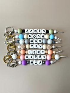 several key chains with letters and beads attached to them