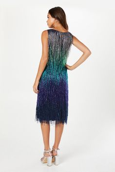 Exquisite hand-embellished sequin fringe design
Stunning ombré effect from dark to light tones
Sleeveless silhouette with a high neckline
Midi length for a sophisticated look
Shimmering glass beads for added sparkle
Make a dazzling entrance at your next special occasion with this show-stopping sequin fringe mini dress from Coast. The hand-embellished design features a mesmerising ombré effect, transitioning from darker hues at the top to lighter shades towards the hem. Perfect for weddings, races, or any formal event where you want to shine. Style this eye-catching piece with strappy metallic heels and a clutch bag for a glamorous ensemble. For cooler evenings, drape a sleek wrap or bolero over your shoulders to maintain an elegant silhouette. The midi length and high neckline offer a re Fringe Midi Dress, Dark To Light, Fringe Mini Dress, Metallic Heels, Ombre Effect, Dresses Party, Fashion Face, High Neckline, Dress Clothes For Women